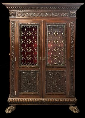 an antique wooden cabinet with a glass door and ornate carvings
