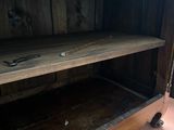 a wooden cabinet with a shelf on top of it