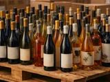 many bottles of wine sitting on a wooden pallet