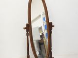 a mirror that is sitting on a stand in a room
