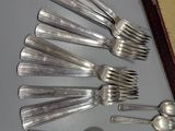 a lot of silver spoons and spoon spoons on a table