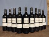 six bottles of wine are lined up in a row on a table