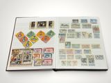 an open book with stamps on it on a table