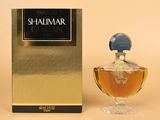 an image of a bottle of shalimar perfume next to a box