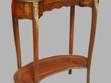 an image of a wooden table with a red leather top