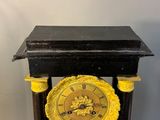 a black and gold clock sitting on top of a table