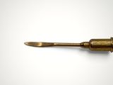 an old brass screw with a wooden handle on a white background