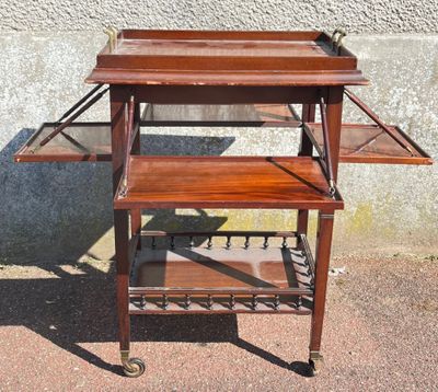 a small wooden table with two shelves on it
