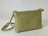a small green purse with a gold chain strap on a white background