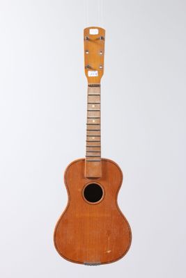 an image of a guitar hanging from a string on a white wall