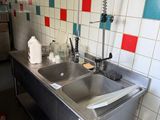 a stainless steel sink with a faucet in the middle of it