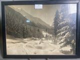 an old picture of a snowy mountain scene with trees in the foreground
