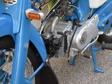 a blue motorcycle parked on the side of the road