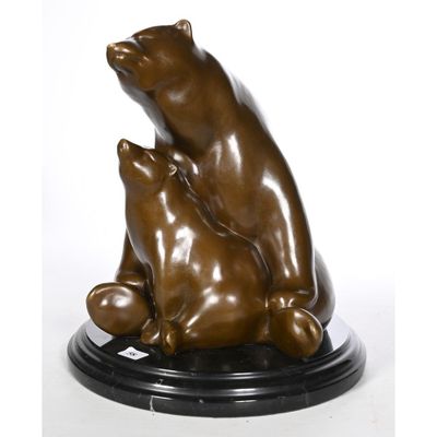 sculpture of a mother bear and her two cubs sitting on a black base