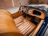 a brown leather seat in the back of an old car