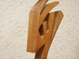 a wooden sculpture that is on a wooden table