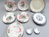 many plates and bowls that are sitting on a table