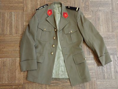 military jacket with red buttons on the lapel on a wooden floor