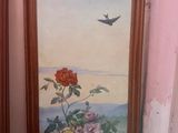 two framed pictures of flowers and a bird on the wall