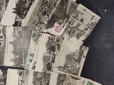 a pile of old postcards sitting on top of a table