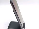 a cell phone on a stand on a white surface
