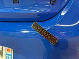 a sticker on the bumper of a blue car