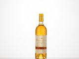 a bottle of wine sitting on top of a table next to a white wall