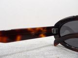 a close up of a pair of sunglasses on a white surface