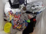a pile of clothing and toys in a plastic bag