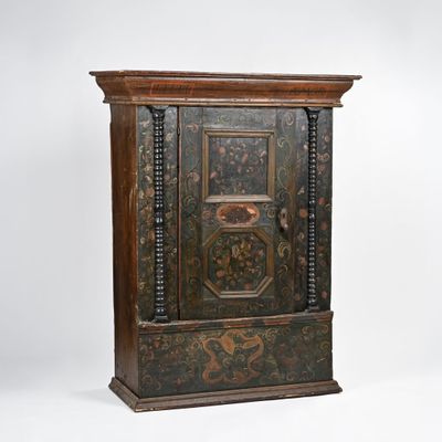 an old wooden cabinet with ornate designs on the doors