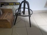 a stool sitting on a tiled floor next to a box
