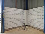 a camera on a tripod in front of a wall