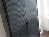 an image of a black cabinet in a bedroom
