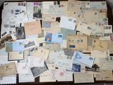 a table with many old letters and stamps on it