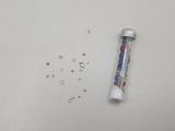 an image of a bottle of water and some beads on a table