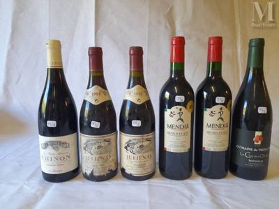 several bottles of wine are lined up on a table