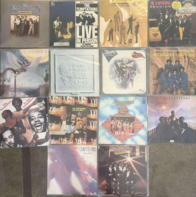 many different album covers on the wall of a room