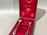 a red box with silverware in it on a table