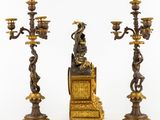 pair of antique brass candlesticks with a dragon on top of a box