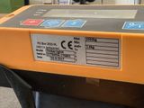 an orange and black machine sitting on top of a black table