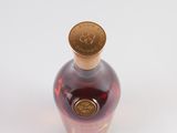 a bottle of liquor that is sitting on a white surface
