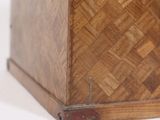 an old wooden box sitting on top of a white surface