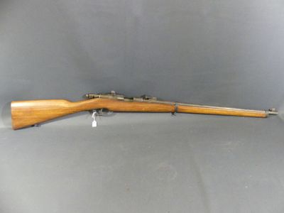 a rifle with a wooden barrel on a grey background