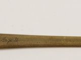an image of a gold axe on a white surface