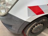 a close up of a van with a red and white stripe on the side