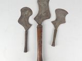 three old metal tools on a white surface with a white background
