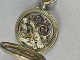 a silver pocket watch with a chain attached to it