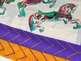 purple, orange, and white table runner with horses and chevrons on it