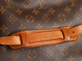 a close up of a louis vuitton bag with a leather strap
