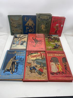 several children ' s books are lined up on a white surface